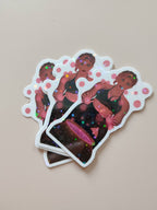 3 stickers Stella posé à plan sur un fond neutre qui brillent au soleil